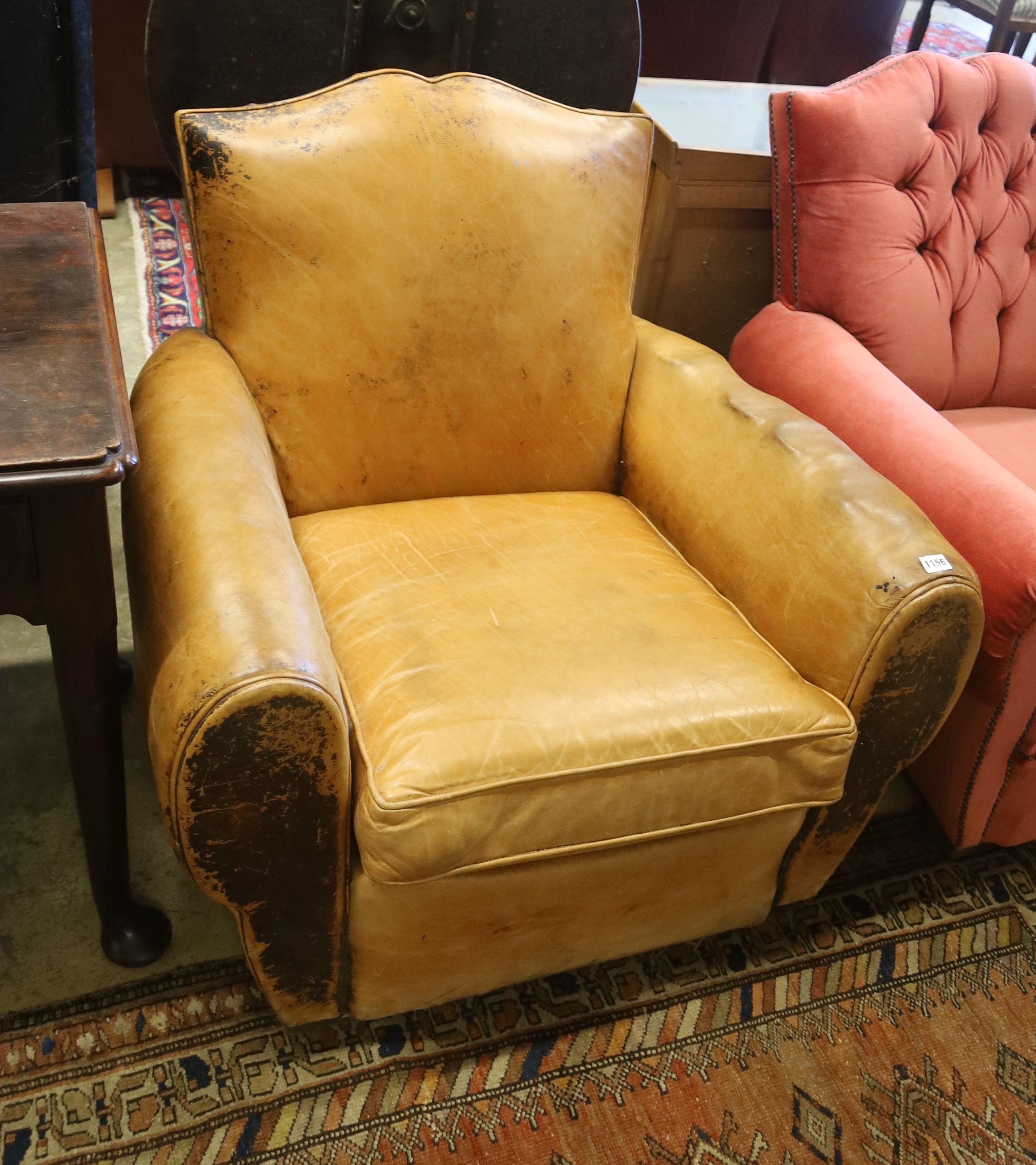 An early 20th century French tan leather armchair, width 86cm, depth 84cm, height 77cm